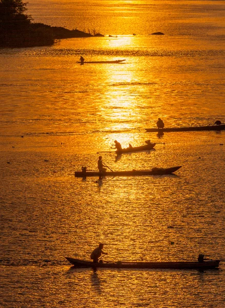 Beaucoup de pêcheur pagayant bateau à rames à la pêche au coucher du soleil, Silhouet — Photo