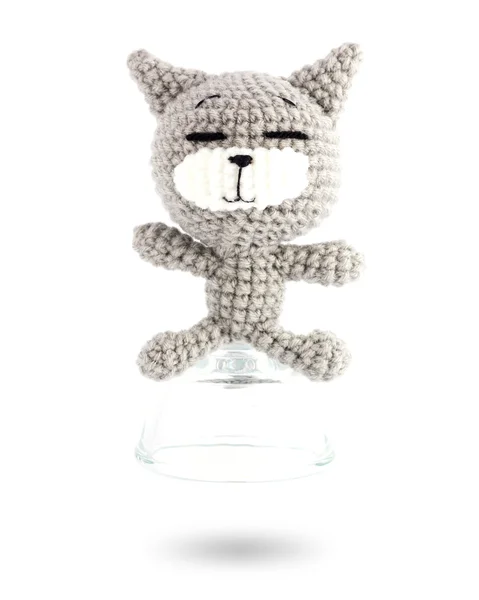 Handmade crochet gray cat doll in vodka glass on white backgroun — Stock Photo, Image