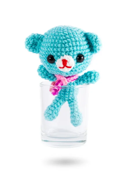 Handmade crochet blue bear doll in vodka glass on white backgrou — Stock Photo, Image