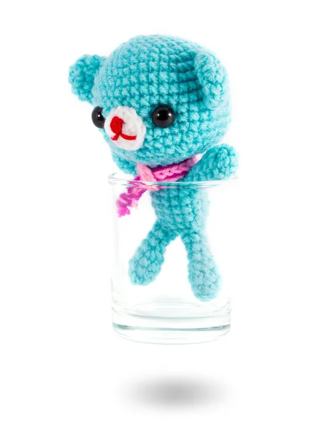 Handmade crochet blue bear doll in vodka glass on white backgrou — Stock Photo, Image