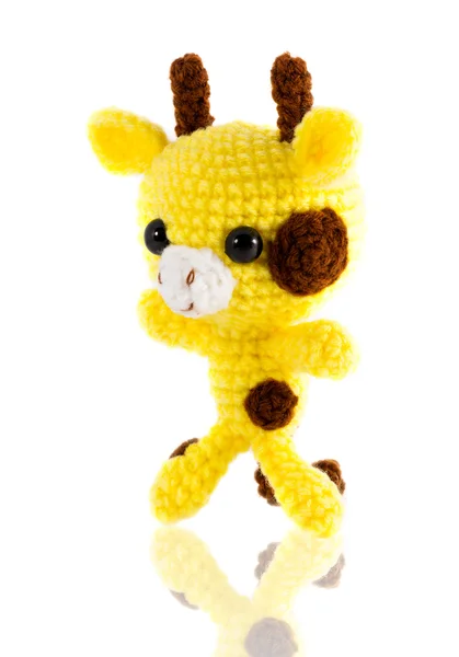 Handmade crochet yellow giraffe doll on white background, left s — стоковое фото