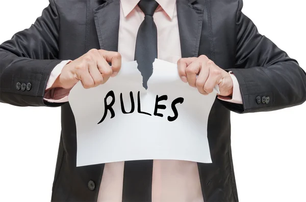 Businessman ripping up the RULES sign on white background — Stock Photo, Image