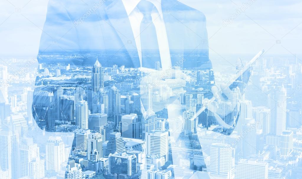 Double exposure of businessman with cityscape