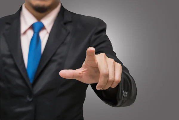 Empresario señalando o tocando sobre fondo gris — Foto de Stock