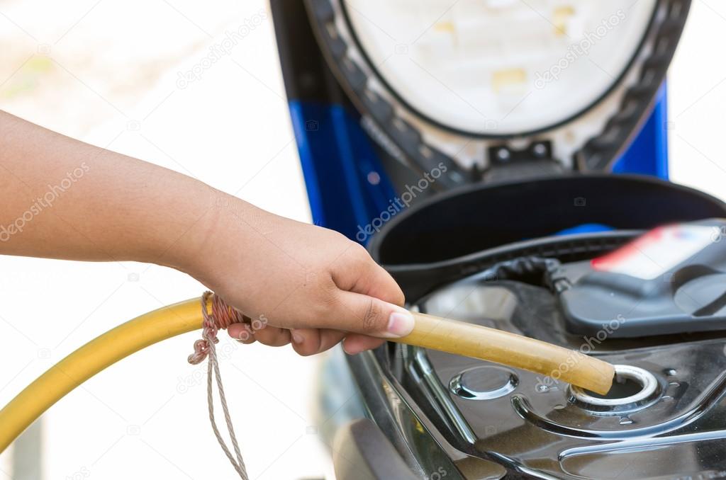hold traditional rubber tube to add fuel in motorcycle
