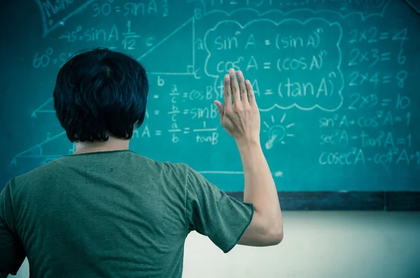 Raised hands in classroom at School — Stock Photo, Image