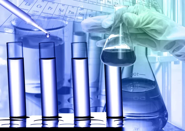 Chemical Laboratory,scientist dropping the reagent to test tube — Stock Photo, Image