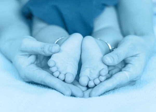 Piedi bambino sulla mano delle madri — Foto Stock