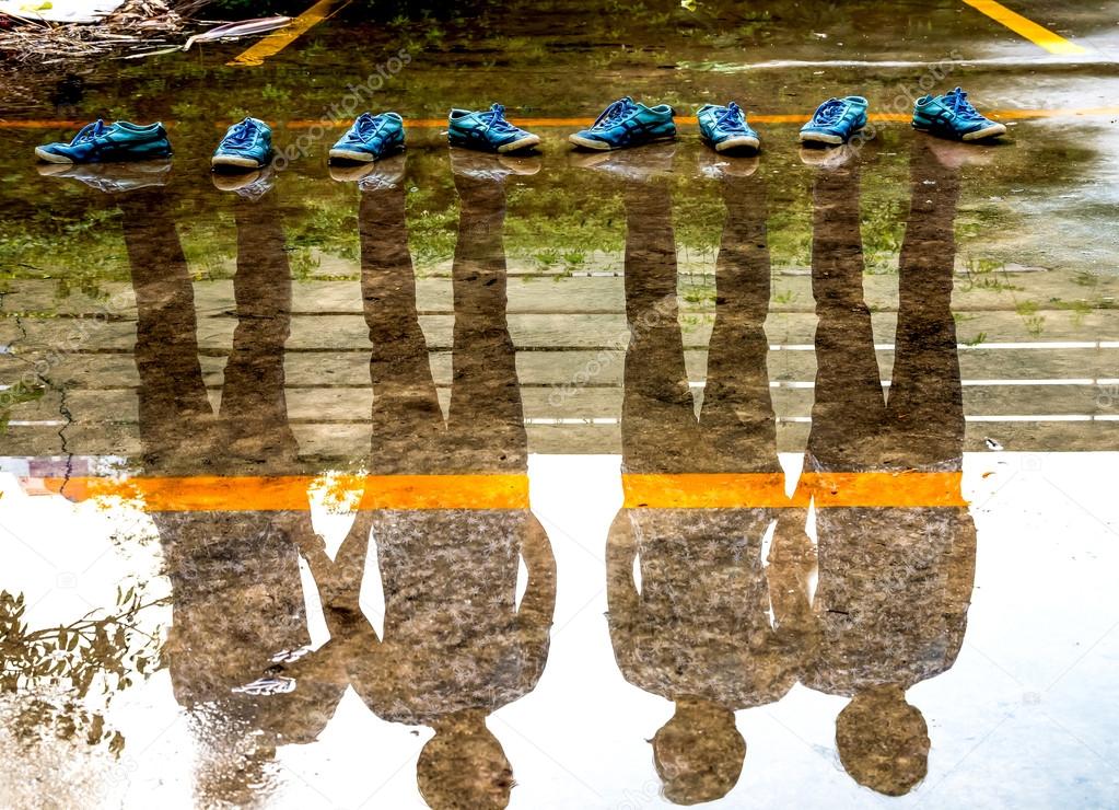 Four man reflection in the water after raining, double exposure 