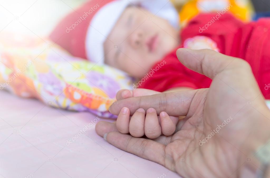 Asian baby hand on the adult hand