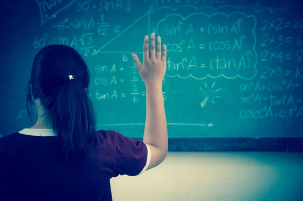 Raised hands in classroom at School — Stock Photo, Image