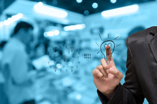 Abstract blurred photo of book store with Businessman pointing the idea on people background, blue color tone — Stock Photo, Image