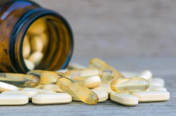 Prášky nebo vitaminu v lahvích medicíny na pozadí — Stock fotografie