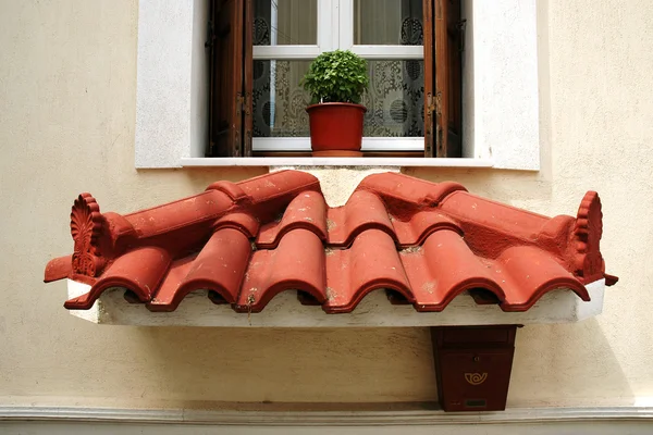 Small decorative roof below the window — Stock Photo, Image