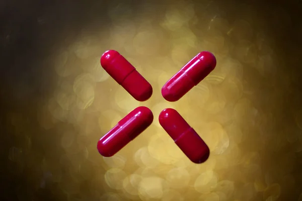 Oval Red Pills Cross Aid All Diseases Gold Bokeh Background — Stock Photo, Image