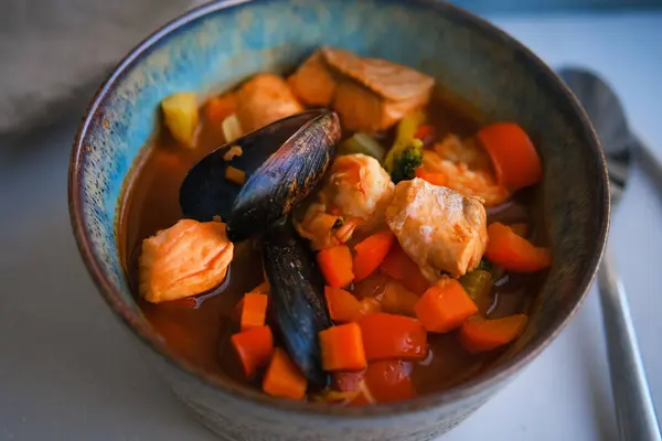 Bowl of fresh seafood soup with mussels