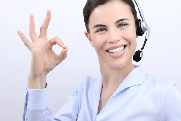 Customer service operator smiling woman with headset ok hand sig — Stock Photo, Image