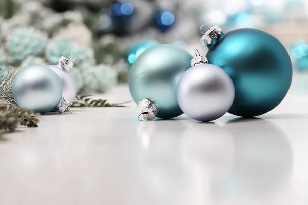merry christmas background, silver and blue christmas balls and decorations on white table, useful as a greeting card template with copy space