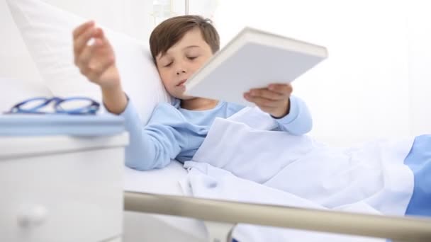 Child Hospital Lying Bed Bored Taking Book Read — Stock Video