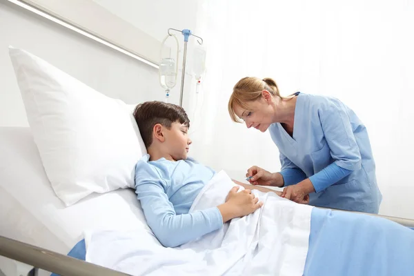 Enfermera Medicando Niño Enfermo Acostado Cama Consiguiéndole Goteo Hospital — Foto de Stock