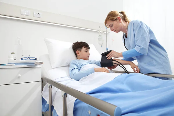 Child Lying Bed Hospital Room Nurse Measuring His Pressure Sphygmomanometer — Stockfoto