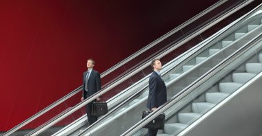 Business man going up and down escalators, concept of success clipart