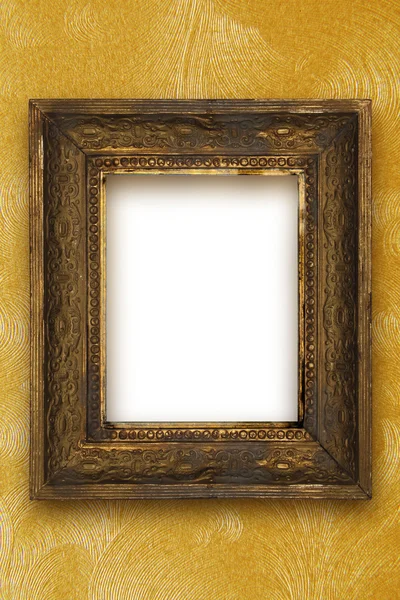 Classic old wooden picture frame carved by hand on gold wallpaper background — Stock Photo, Image