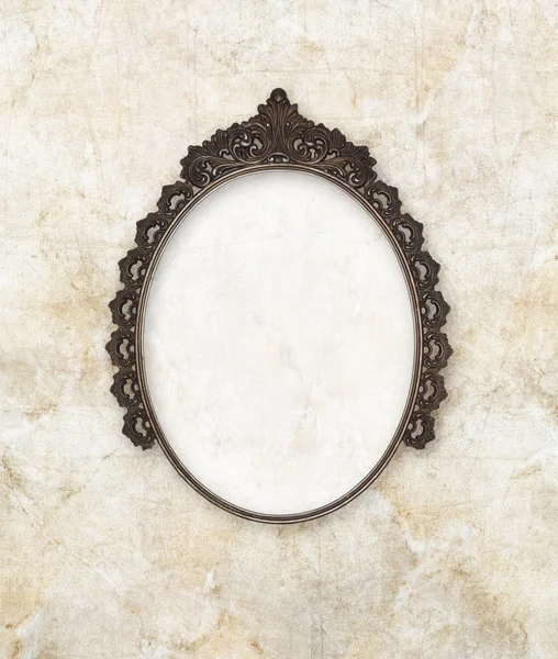 Old oval picture frame metal worked on marble background — Stock Photo, Image