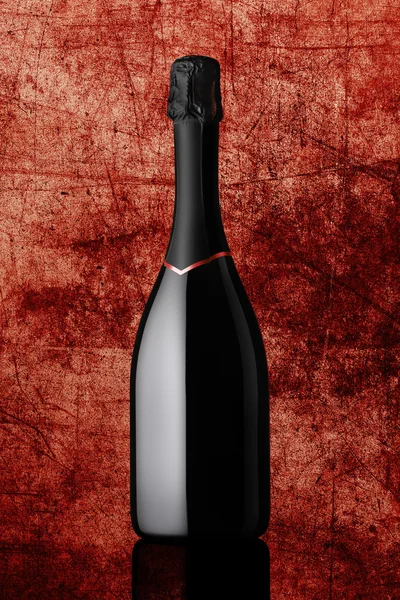 Bottle of sparkling wine on colorful red background — Stock Photo, Image