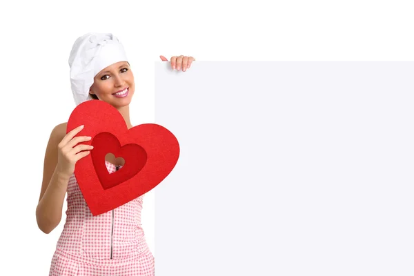 Chef mujer mostrando cartelera con forma de corazón —  Fotos de Stock