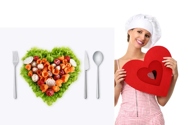 Concept vegetarian diet chef woman pointing billboard salad heart shape — Stok Foto