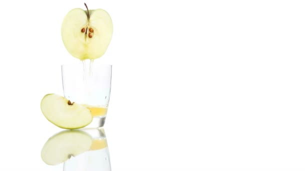 Apple juice poured into the glass isolated on white background — Stock Video