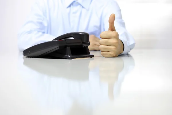 Like hand with office phone on desk — Stock Photo, Image