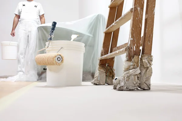 Painter man at work with a roller, bucket and scale, bottom view — Stock Image Painter man at work with a roller, bucket and scale, bottom view Stock Image