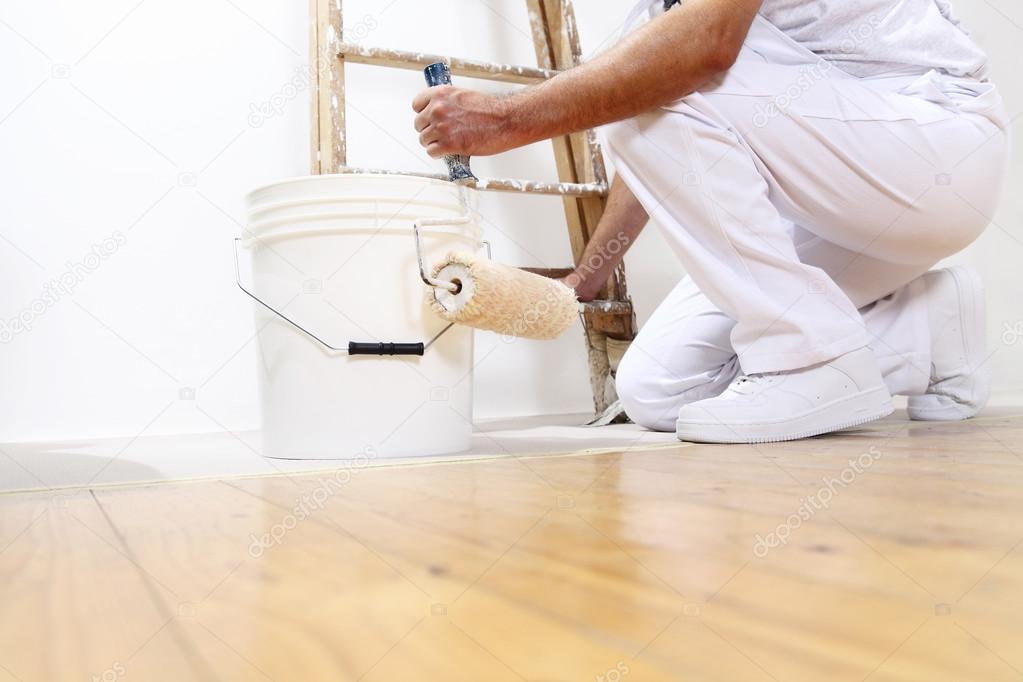 painter man at work with a roller, bucket and scale, bottom view