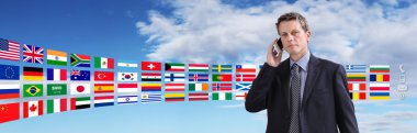 International contact, business man talking on phone with flags clipart