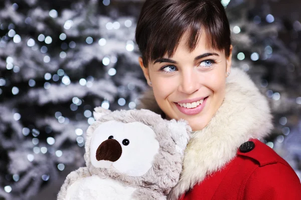 Christmas woman smiling with owl toy decoration, looks up — Stock Photo, Image