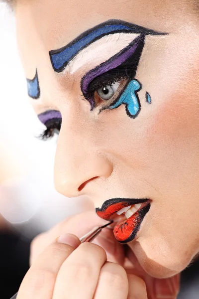 Makeup artist applying lipstick on model lips with brush, closeu — Stock Photo, Image