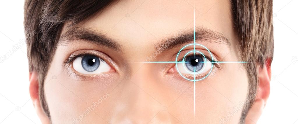 Closeup of blue eyes from a young man and laser hologram