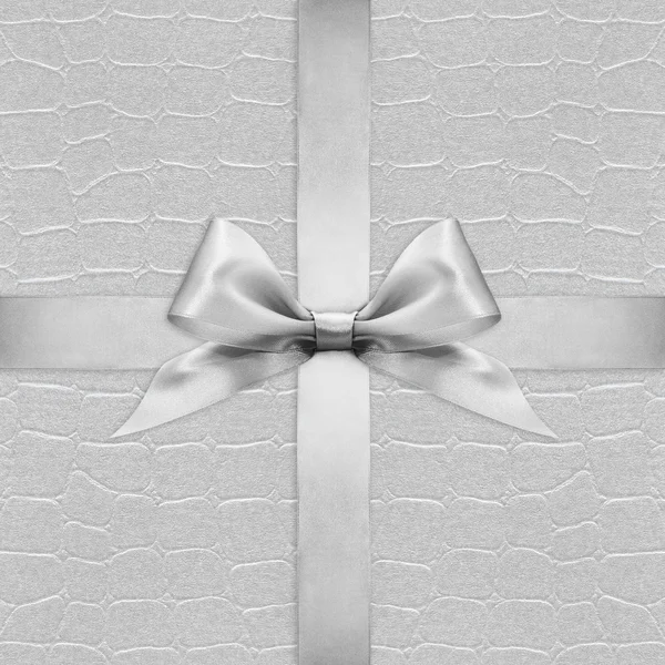 Shiny silver satin ribbon bow on argent background