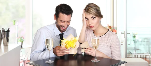 Couple exchanging gifts on a date, to the surprise — Stock Photo, Image