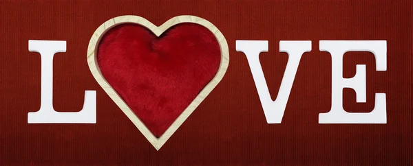 Liebestext mit Herzform isoliert auf rotem Kartonhintergrund — Stockfoto