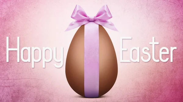 Texto de Páscoa com ovo de Páscoa de chocolate e laço de fita rosa — Fotografia de Stock