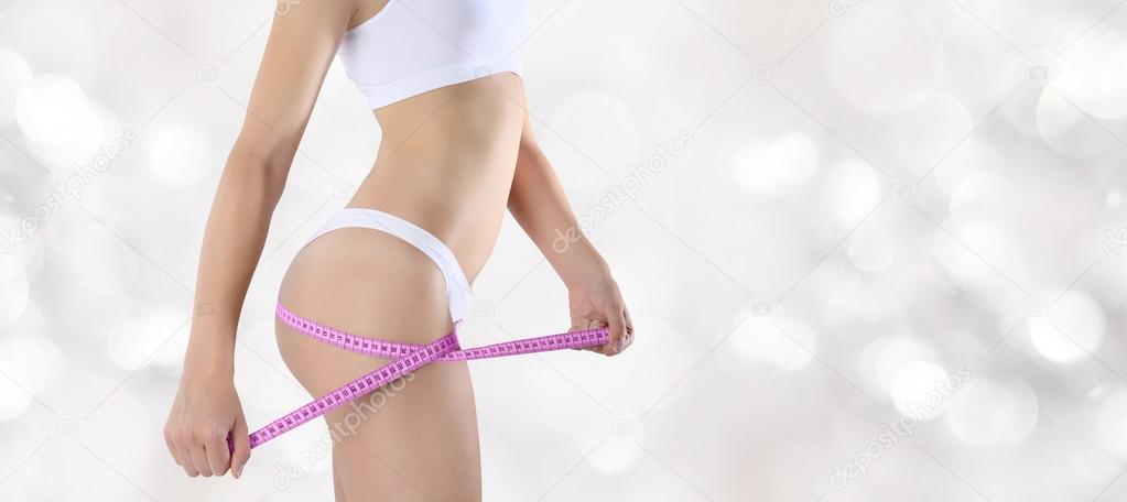 hand with meter, bum and legs of slim woman isolated on blurred 