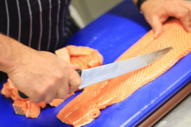 man preparing fresh fish clipart