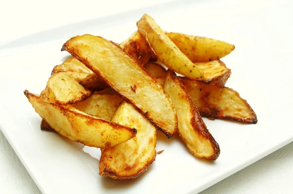 Spicy baked potato wedges — Stock Photo, Image