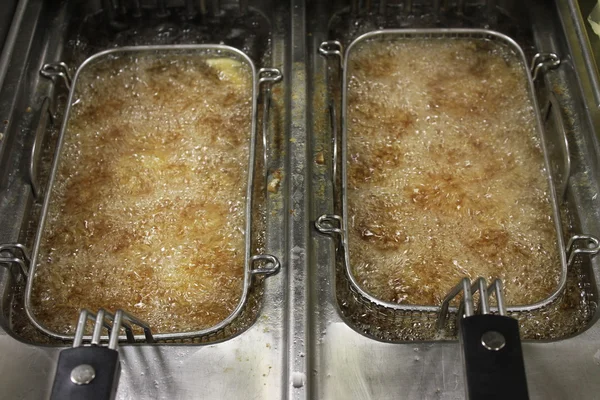 Deep frying chipped potatoes — Stock Photo, Image