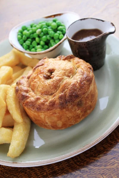 Steak and mushroom pie with chips and peas — Stock Photo, Image