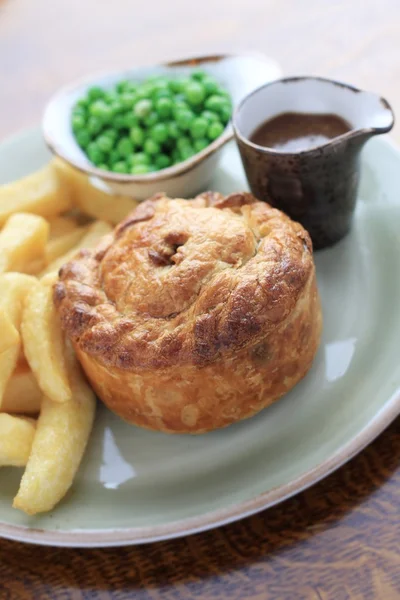 Steak and mushroom pie with chips and peas — Stock Photo, Image