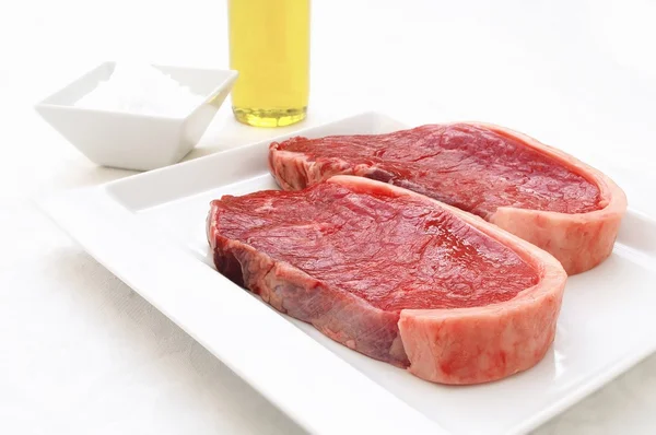 Raw uncooked steaks — Stock Photo, Image
